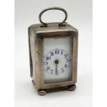 A miniature hallmarked silver clock with white enamelled dial - movement loose in case