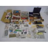 A large collection of model railway accessories and spare parts including model kit buildings,