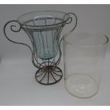 A wrought iron centre piece with glass vase, along with large circular glass vase