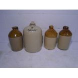 A collection of four stoneware flagons, one marked with M.Holman Bishop & Son Brewers (Lewes)
