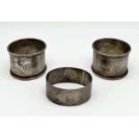 A pair of hallmarked silver napkin rings along with one other