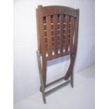 A weathered teak single garden chair.