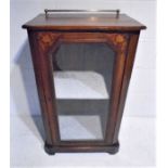 An Edwardian inlaid display cabinet with brass rail.