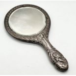 A hallmarked silver hand mirror decorated with cherubs