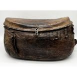 An antique Eastern leather and wicket basket -possibly Omani, with stitched hide remains of fringing