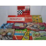 A collection of classic board games and jigsaw puzzles including Monopoly, Othello, Cluedo, Tri-