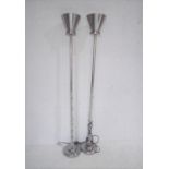 A pair of faux flame metal torchiere floor lamps.