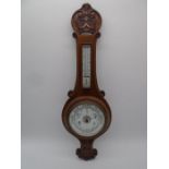 A carved oak Aneroid banjo barometer with white enamelled dial