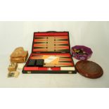 A backgammon set along with a solitaire board, checkers, a music box in the form of a grand piano