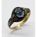 A Victorian 15ct gold ring decorated with cameo style flower and seed pearls (1 missing)