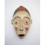A carved wooden tribal mask, height 37cm.