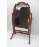 An Antique walnut veneer toilet mirror.