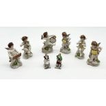 A set of Capodimonte porcelain figures of putti playing musical instruments each on scroll bases