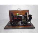 A cased vintage Naumann sewing machine