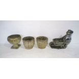 A pair of stone garden urns, along with another urn and a stone planter in the form of a badger