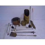 A collection of brassware including water can, coal scuttle, toasting forks, horse brasses, fireside
