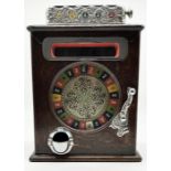 An early 20th century oak cased Caille roulette slot machine 54cms high - appears to be in working