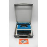 A vintage boxed Underwood 315 typewriter with instruction manual.