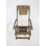 An Eastern Indonesian garden steamer chair with carved decoration, A/F.