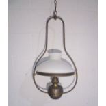 A turn of the century hanging oil lamp with glass shade, converted for use with bulbs.