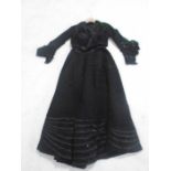 A Victorian two piece black dress decorated with lace and beads in antique Dickens & Jones cardboard