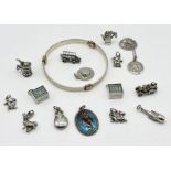 A collection of silver jewellery charms, St Christopher, bangle etc.