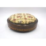 A Victorian inlaid tapestry stool with ceramic feet.
