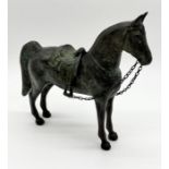 A patinated bronze figure of a horse with detachable saddle - height 25cm
