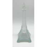A glass bottle with stopper in the form of the Eiffel Tower