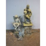 A stone classical figure of a lady on a plinth, along with two fairy garden ornaments.