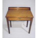 A pitch pine clerk's desk with ebonised detail on camphor legs.