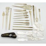 A collection of mother of pearl gaming tokens, bone sewing implements, penknife etc.