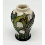 A miniature Moorcroft vase with Snowdrop decoration, signed and stamped to base - height 5cm