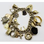 A 9ct gold charm bracelet with a large quantity of various hallmarked charms including bagpipes