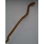 A vintage carved walking stick in the form of a snake