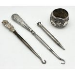 A small collection of silver including button hook in the form of Toby the dog, eastern napkin ring,