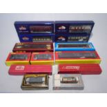 A collection of various boxed model railway 00 gauge carriages and rolling stock including Hornby,