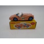 A vintage boxed Dinky Toys die-cast Triumph TR2 Sports car (No 111) with pink body and blue interior