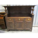 An oak Arts and Crafts sideboard, stamped 10551 to centre drawer, length 168cm, height 151cm.