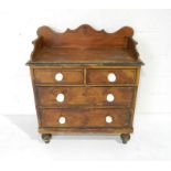 An antique painted pine chest of four drawers with original detailing raised on turned legs - length