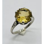 A citrine ring set in white metal