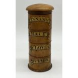 An antique treen spice tower of cylindrical form with four named sections, "Mace", "Cloves", "