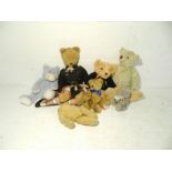 A small collection of teddy bears including some vintage, along with two books about teddy bears