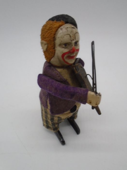 Three vintage Schuco clockwork tinplate toys in the form of clowns playing the violin (one with an - Image 6 of 11