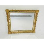 An ornate gilt framed rectangular wall mirror, 66cm x 76cm.