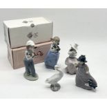 A collection of Nao figures including two in boxes and a Lladro duck