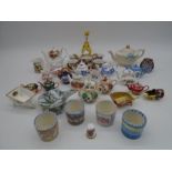 A collection of miniature tea pots and other items