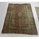 A faded Eastern red ground rug - 339cm x 221cm