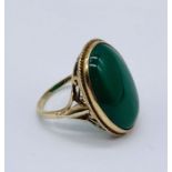 A 9ct gold ring set with a large green stone