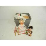 A doll along with a quantity of dolls clothes etc